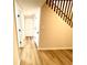 Hallway with hardwood floors leading to several bedrooms and staircase at 2535 Impala Dr, Cumming, GA 30041