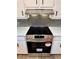 Stainless steel stove and vent hood above the glass cooktop at 2535 Impala Dr, Cumming, GA 30041