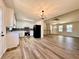 Open-concept living room and kitchen area with modern flooring and plenty of light at 2535 Impala Dr, Cumming, GA 30041