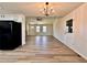 Open-concept living room and kitchen boasts modern lighting and wood-look vinyl flooring at 2535 Impala Dr, Cumming, GA 30041