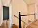 Staircase features carpet steps and a wooden railing and decorative door at 2535 Impala Dr, Cumming, GA 30041