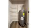Utility closet with storage shelves and Rheem hot water tank at 2535 Impala Dr, Cumming, GA 30041