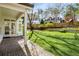 Backyard with artificial turf, a brick patio, mature trees, and a wooden play set at 2955 Rhodenhaven Nw Dr, Atlanta, GA 30327