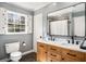 Bathroom featuring double sink vanity, updated fixtures, and shutters on the window at 2955 Rhodenhaven Nw Dr, Atlanta, GA 30327