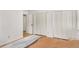 Bedroom with hardwood floors and white closet with bi-fold doors and an open doorway at 2955 Rhodenhaven Nw Dr, Atlanta, GA 30327