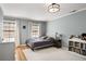 Comfortable bedroom features a large window, hardwood floors, and ample natural light at 2955 Rhodenhaven Nw Dr, Atlanta, GA 30327