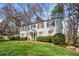 Two-story home with a well-manicured lawn, garden, and a classic brick walkway at 2955 Rhodenhaven Nw Dr, Atlanta, GA 30327