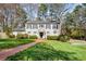 Lovely two-story home with shutters, a brick pathway, and a lush green lawn at 2955 Rhodenhaven Nw Dr, Atlanta, GA 30327