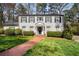 Charming two-story home with a brick pathway, beautiful lawn, and well-maintained landscaping at 2955 Rhodenhaven Nw Dr, Atlanta, GA 30327