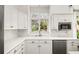 Close up of the kitchen sink, window, stainless dishwasher and tile backsplash at 2955 Rhodenhaven Nw Dr, Atlanta, GA 30327