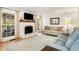Cozy living room with a white brick fireplace, large windows, and comfortable seating at 2955 Rhodenhaven Nw Dr, Atlanta, GA 30327