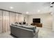 Cozy living room features tile floors, a gray sofa, a TV, and sheer curtains at 2955 Rhodenhaven Nw Dr, Atlanta, GA 30327