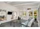 Screened porch featuring white brick, a white ceiling, a ceiling fan and views of the backyard at 2955 Rhodenhaven Nw Dr, Atlanta, GA 30327