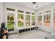 Bright sunroom with ample windows overlooking the backyard with a playground and a grill at 2955 Rhodenhaven Nw Dr, Atlanta, GA 30327