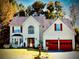 Charming two-story home with a well-manicured lawn, red garage doors, and inviting curb appeal at 475 Cascade Rise, South Fulton, GA 30331