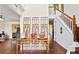 Inviting foyer with hardwood floors, a staircase, and decoratively furnished console table at 475 Cascade Rise, South Fulton, GA 30331