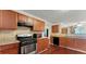 Well-lit kitchen with stainless steel appliances, granite countertops, and dark wood cabinetry at 475 Cascade Rise, South Fulton, GA 30331