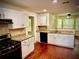 Modern kitchen with white cabinets, granite countertops, stainless steel appliances, and hardwood floors at 475 Cascade Rise, South Fulton, GA 30331