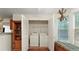 Laundry room with open closet space, side windows, and hardwood floors at 475 Cascade Rise, South Fulton, GA 30331