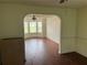 Open living space with hardwood floors, archway, and bright bay windows at 475 Cascade Rise, South Fulton, GA 30331