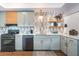Modern kitchen featuring stylish cabinetry, stainless steel appliances, and a leaf-patterned backsplash at 666 Serramonte Drive Dr, Marietta, GA 30068
