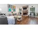 Bright living room featuring a stone fireplace, hardwood floors, and contemporary furnishings at 666 Serramonte Drive Dr, Marietta, GA 30068