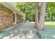 A brick house with a back deck, complete with a tree growing through it, surrounded by trees and a green backyard at 2863 Jordan Forest Trl, Lawrenceville, GA 30044