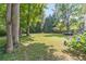 Spacious backyard with lush green grass, mature trees, and flowering shrubs at 2863 Jordan Forest Trl, Lawrenceville, GA 30044