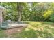 The backyard features a wooden deck, mature trees, and a well-manicured lawn at 2863 Jordan Forest Trl, Lawrenceville, GA 30044