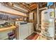Basement laundry area with washer, dryer, water heater, and shelving at 2863 Jordan Forest Trl, Lawrenceville, GA 30044