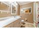 Well-lit bathroom featuring a single sink vanity, neutral paint, and framed mirror at 2863 Jordan Forest Trl, Lawrenceville, GA 30044