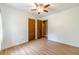 Bedroom featuring wood-look flooring, a ceiling fan, and double-door closets at 2863 Jordan Forest Trl, Lawrenceville, GA 30044