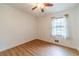 Bedroom with wood-look flooring, ceiling fan, and natural light from the window at 2863 Jordan Forest Trl, Lawrenceville, GA 30044