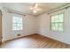 Bedroom with wood floors, ceiling fan, and ample natural light at 2863 Jordan Forest Trl, Lawrenceville, GA 30044