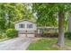 Charming home featuring a 2-car garage, landscaped front yard, and a mix of vinyl siding and brick accents at 2863 Jordan Forest Trl, Lawrenceville, GA 30044