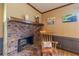 Living room fireplace with brick surround, wood mantel, and neutral decor at 2863 Jordan Forest Trl, Lawrenceville, GA 30044