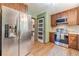Kitchen featuring stainless appliances, wood cabinets, and backsplash at 2863 Jordan Forest Trl, Lawrenceville, GA 30044