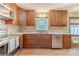 Kitchen featuring custom wood cabinets, tile backsplash, and stainless steel appliances at 2863 Jordan Forest Trl, Lawrenceville, GA 30044