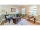 Sitting room featuring hardwood floors, decorative rug, and natural light at 2863 Jordan Forest Trl, Lawrenceville, GA 30044