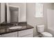 Functional bathroom with granite countertop vanity and a standard toilet, providing essential comfort at 325 Nutwood Trce, Locust Grove, GA 30248