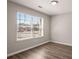 This room features a large window letting in plenty of natural light and hardwood floors at 325 Nutwood Trce, Locust Grove, GA 30248