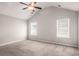 Spacious bedroom featuring a ceiling fan, vaulted ceiling, and natural light from two windows at 325 Nutwood Trce, Locust Grove, GA 30248