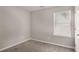Bedroom with carpet, neutral walls, a window, and a white door at 325 Nutwood Trce, Locust Grove, GA 30248