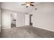 Bedroom featuring neutral walls, carpet, a ceiling fan, and a doorway to the kitchen at 325 Nutwood Trce, Locust Grove, GA 30248
