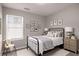 Cozy bedroom featuring a black metal bed frame and soothing neutral tones, perfect for relaxation at 325 Nutwood Trce, Locust Grove, GA 30248