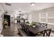 Open-concept dining area leading to a modern kitchen with stainless steel appliances at 325 Nutwood Trce, Locust Grove, GA 30248