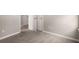 Hallway with carpet, neutral walls, and white doors at 325 Nutwood Trce, Locust Grove, GA 30248