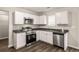 Bright kitchen featuring stainless steel appliances, granite countertops, and white cabinetry at 325 Nutwood Trce, Locust Grove, GA 30248