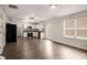 This open floor plan includes a modern kitchen with stainless steel appliances at 325 Nutwood Trce, Locust Grove, GA 30248