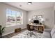 Bright home office featuring large window, modern desk, and comfortable seating area at 325 Nutwood Trce, Locust Grove, GA 30248